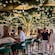 Guests enjoying coffee together at Tiana’s Bayou Lounge aboard the Disney Adventure cruise ship